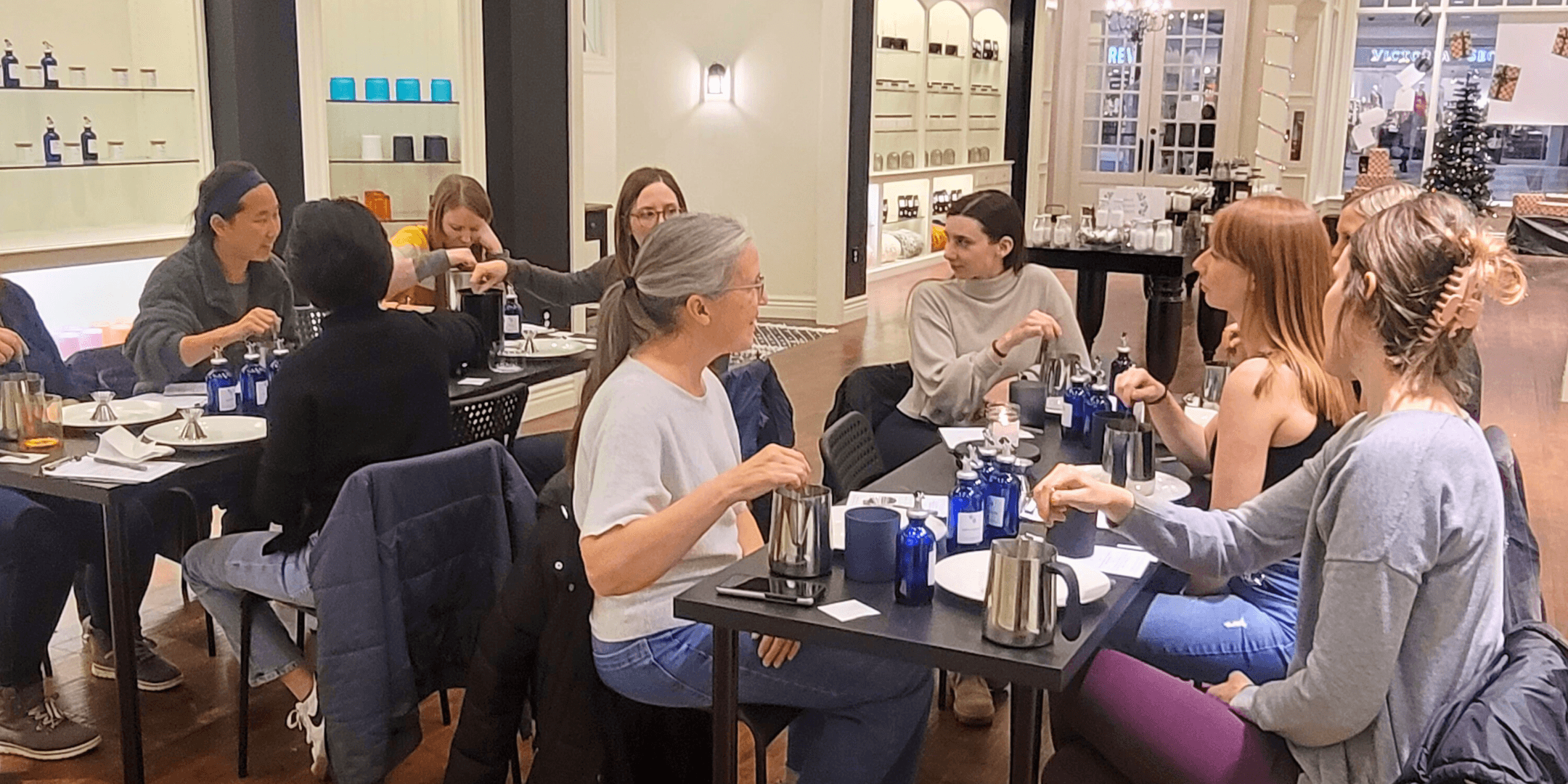 Women seated in studio cafe workshop sharing tea and conversation