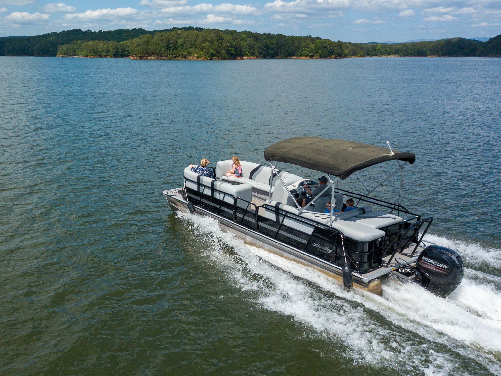 Aerial shot of pontoon boat speeding across Carters Lake