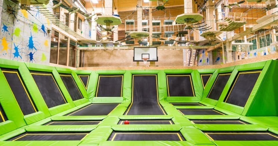 Indoor trampoline court with neon green jump squares and open lanes