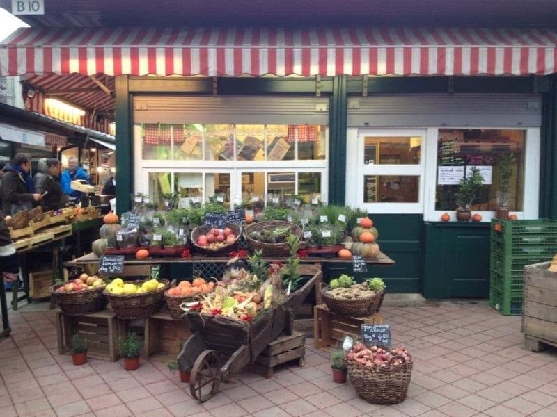 Quaint outdoor greengrocer storefront with produce displays