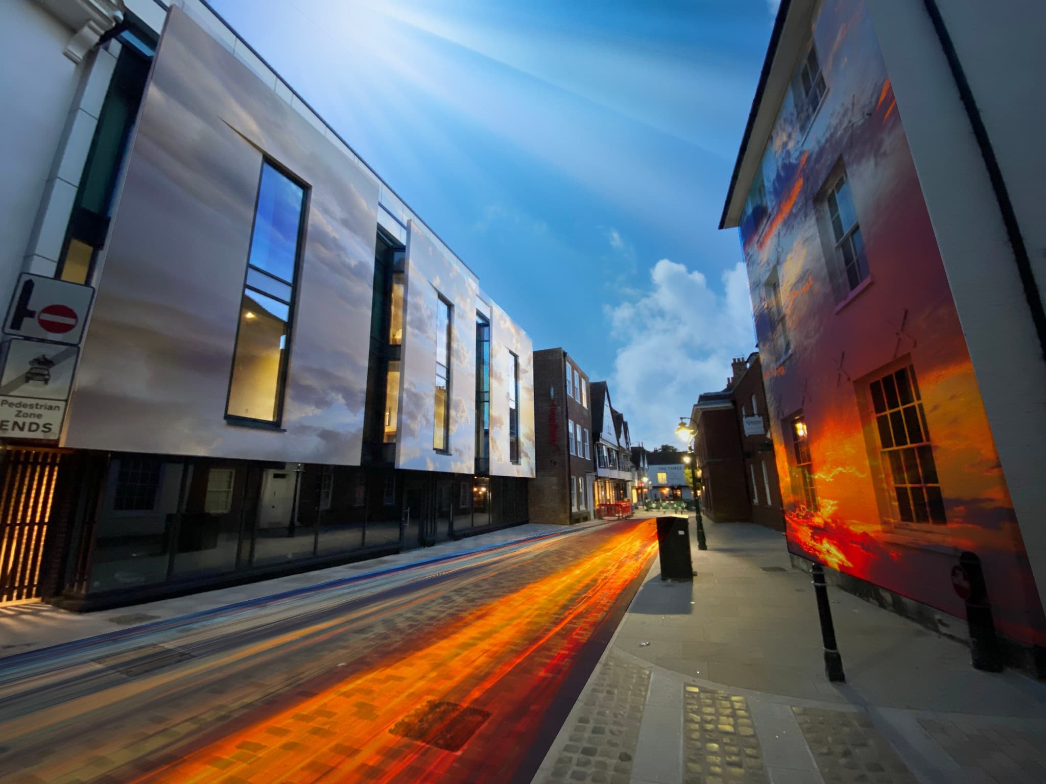 Evening city street with light trails and modern architecture