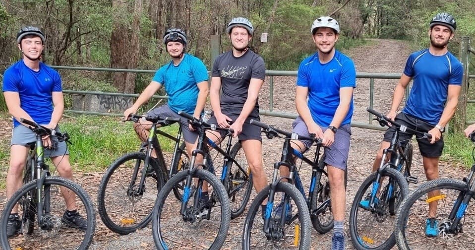 Group cyclists on riverside track ready for Kangaroo Valley mountain ride