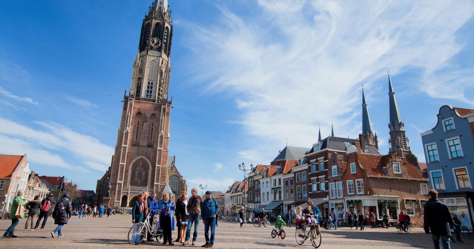 Sightseeing in historic Dutch market square with church tower