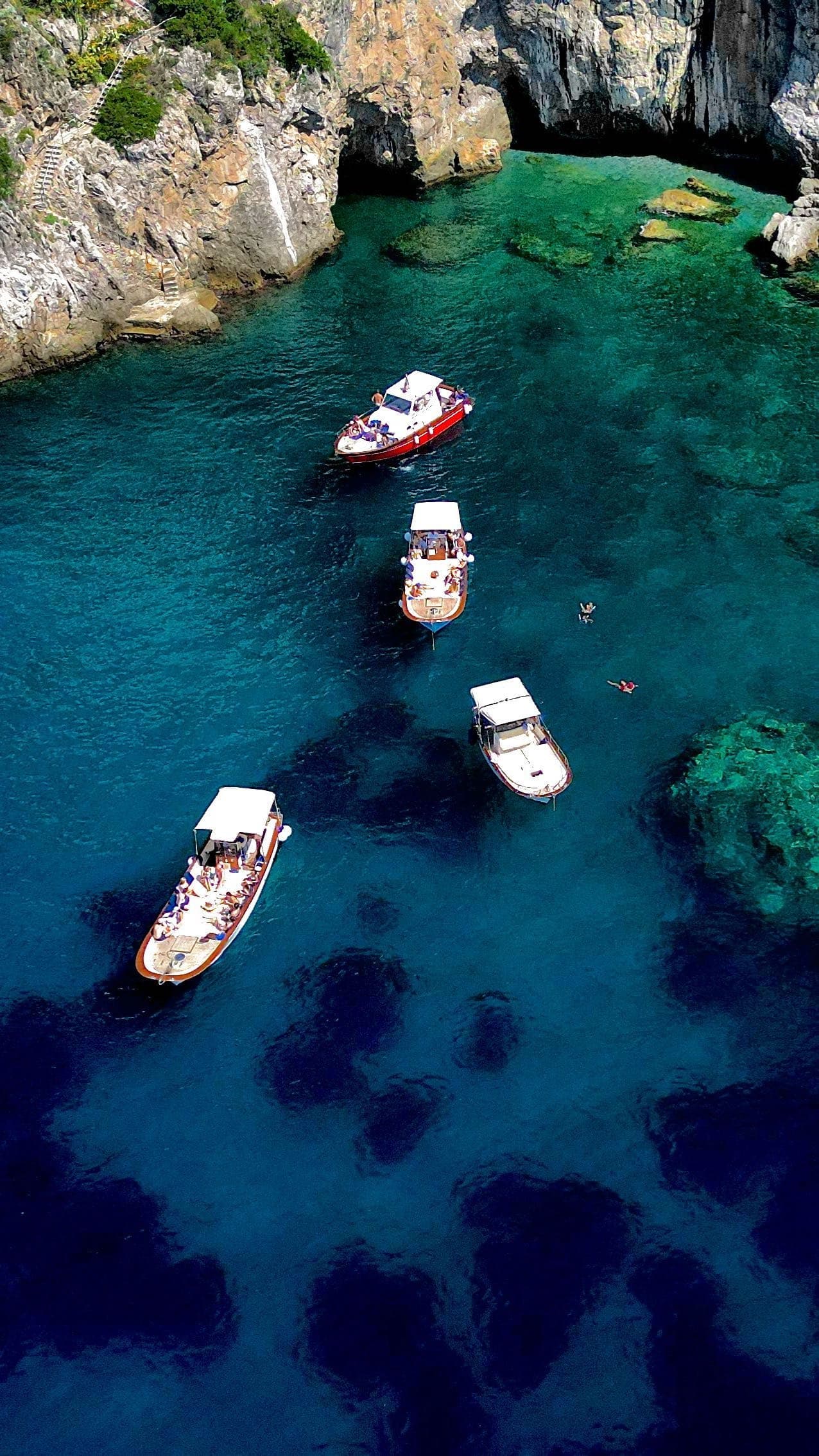 Aerial view of boats over deep blue coves off Amalfi Coast