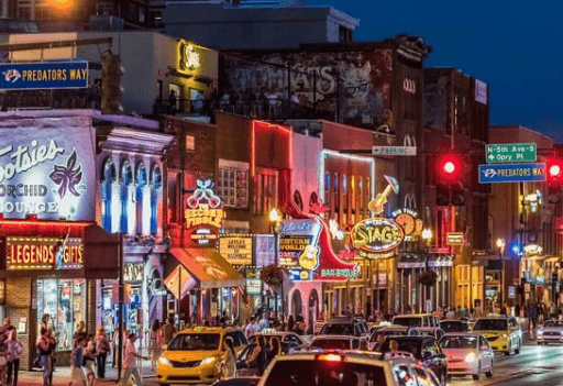 Neon-lit Broadway street nightlife in downtown Nashville at night