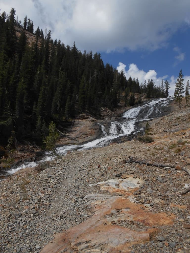 High alpine creek cascading over rocks in mountain valley