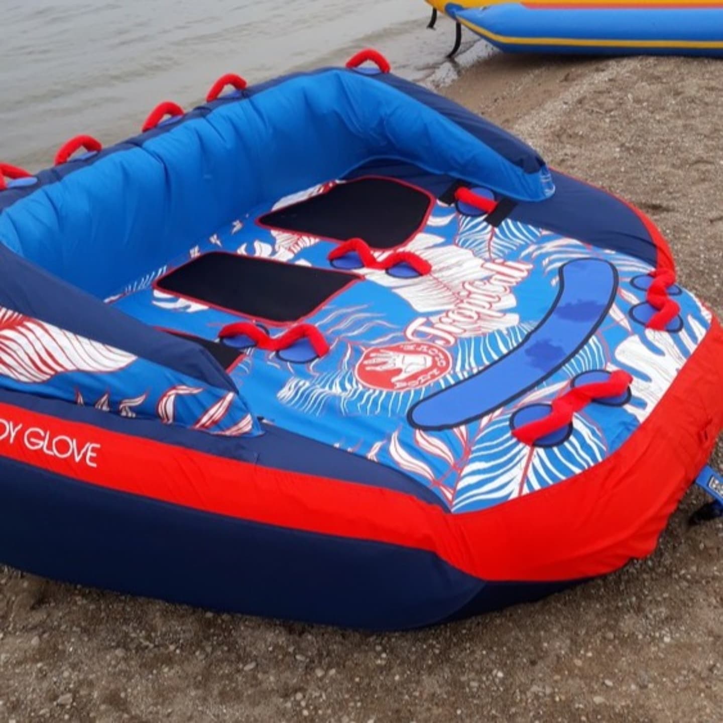 Inflatable towable water tube on lakeshore beach ready for towing