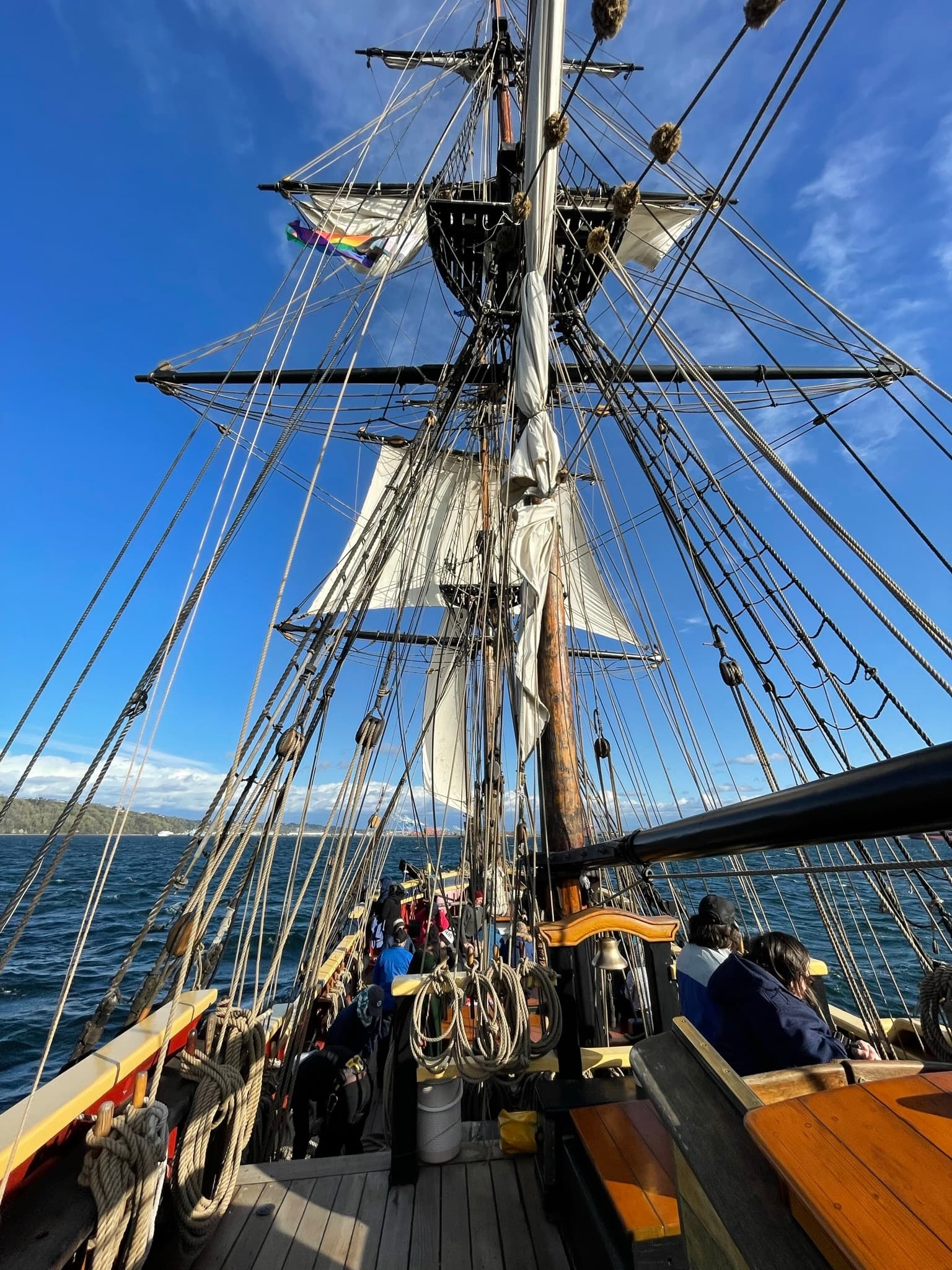 Close-up rigging and crew on historic sailing ship on waterfront