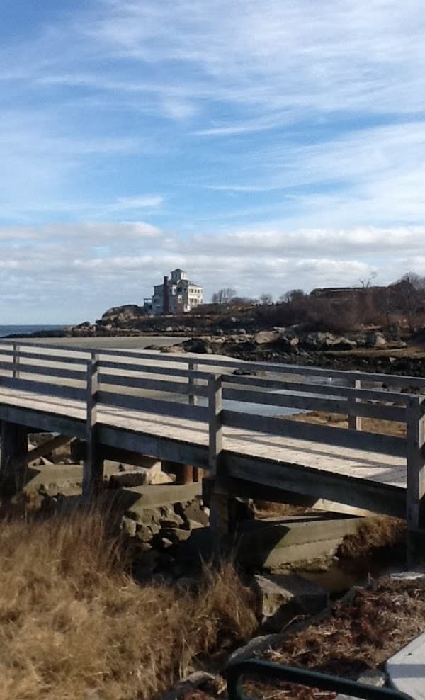 Coastal boardwalk overlooking rocky shoreline and ocean vistas
