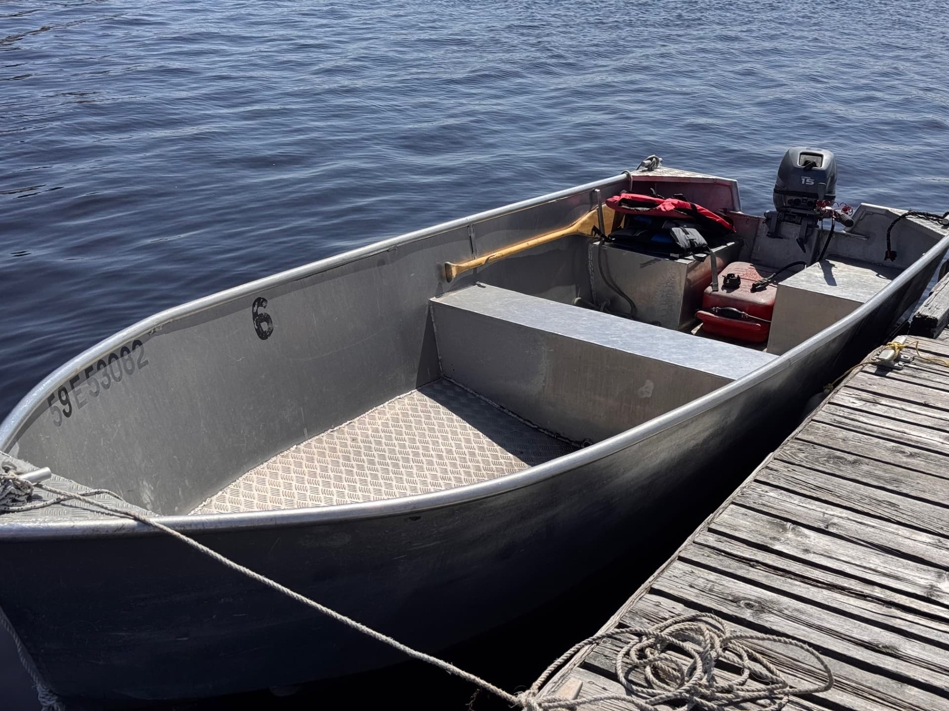 Aluminum fishing skiff moored on open lake at Carling Bay