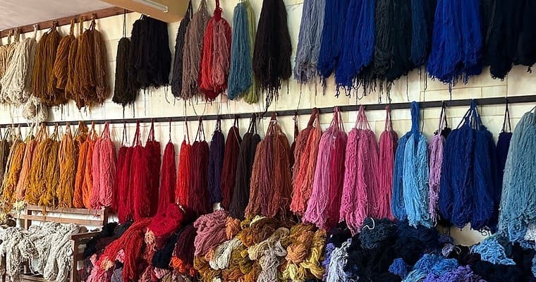 Colorful hand-dyed yarns displayed at Oaxaca artisan market stalls