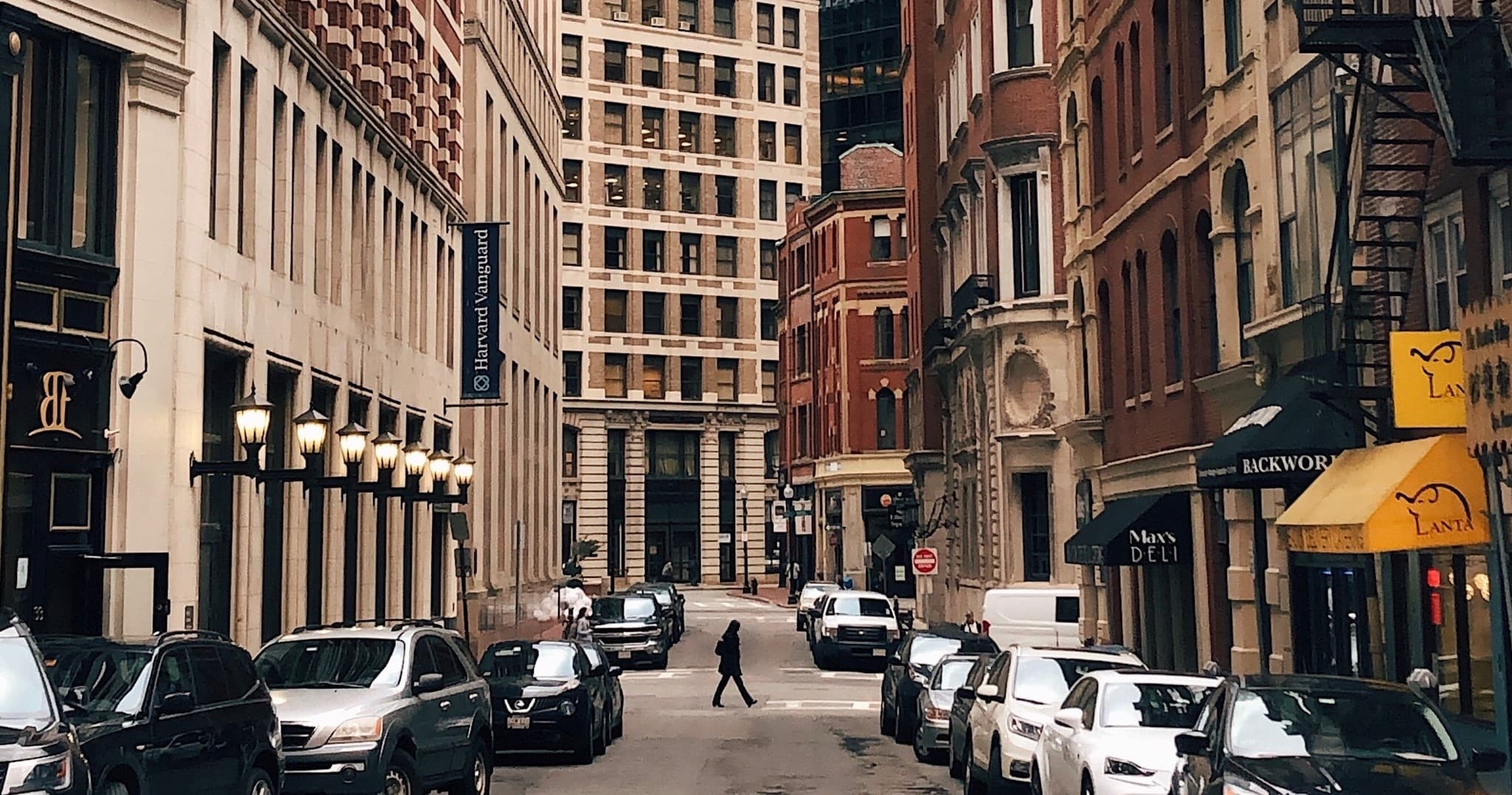 Urban downtown street with cars and pedestrians, city scene