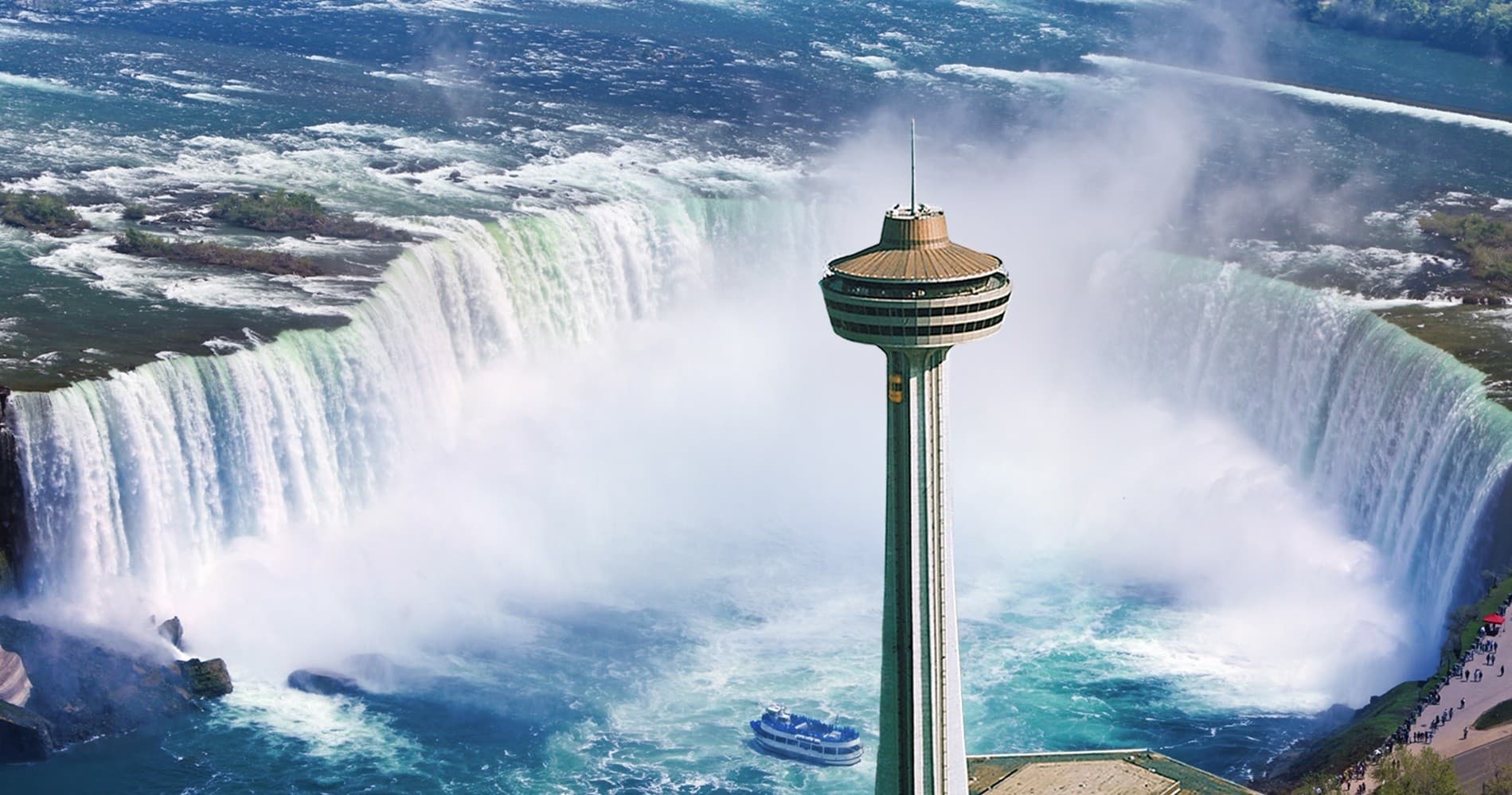 Tour boat approaching Horseshoe Falls with Skylon Tower, Niagara