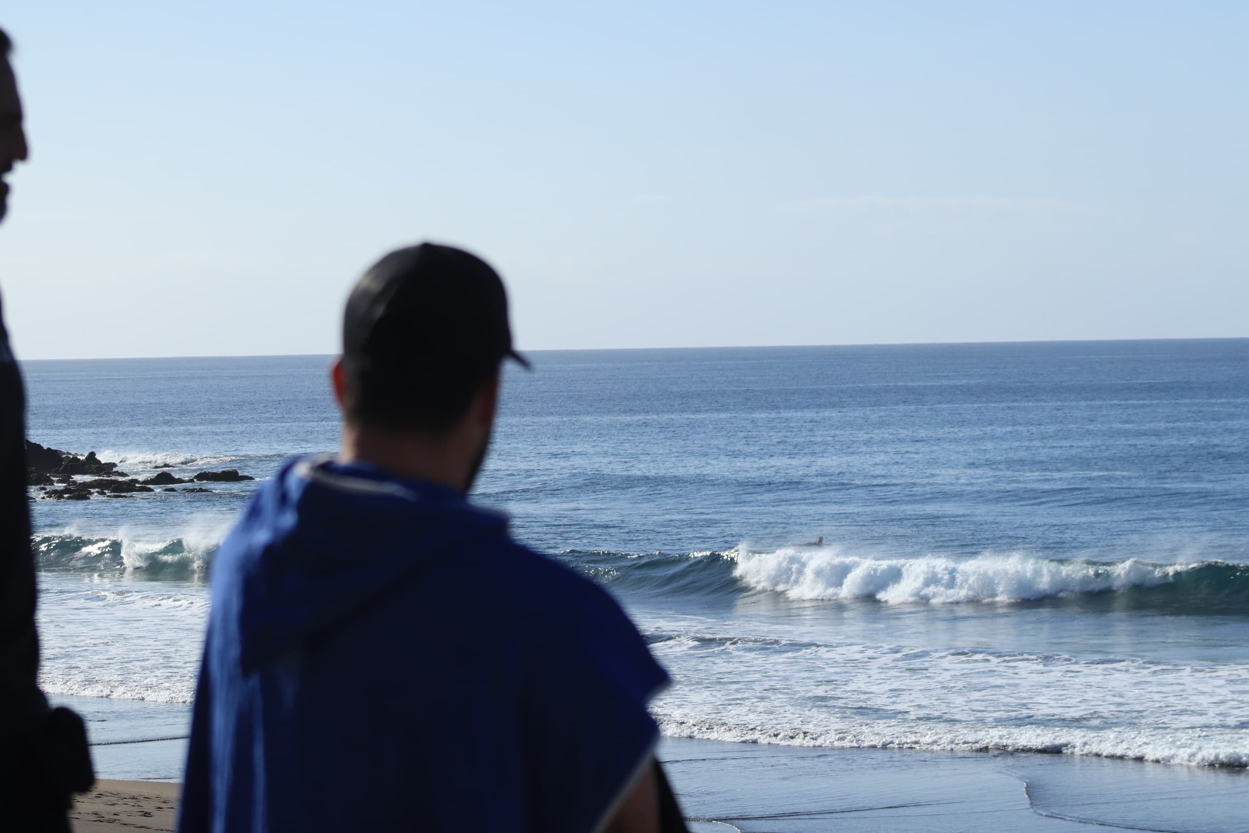 Guide watching incoming waves on Azores coastline viewpoint