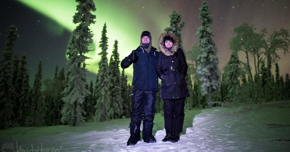 Couple under northern lights during Alaska dog sledding tour