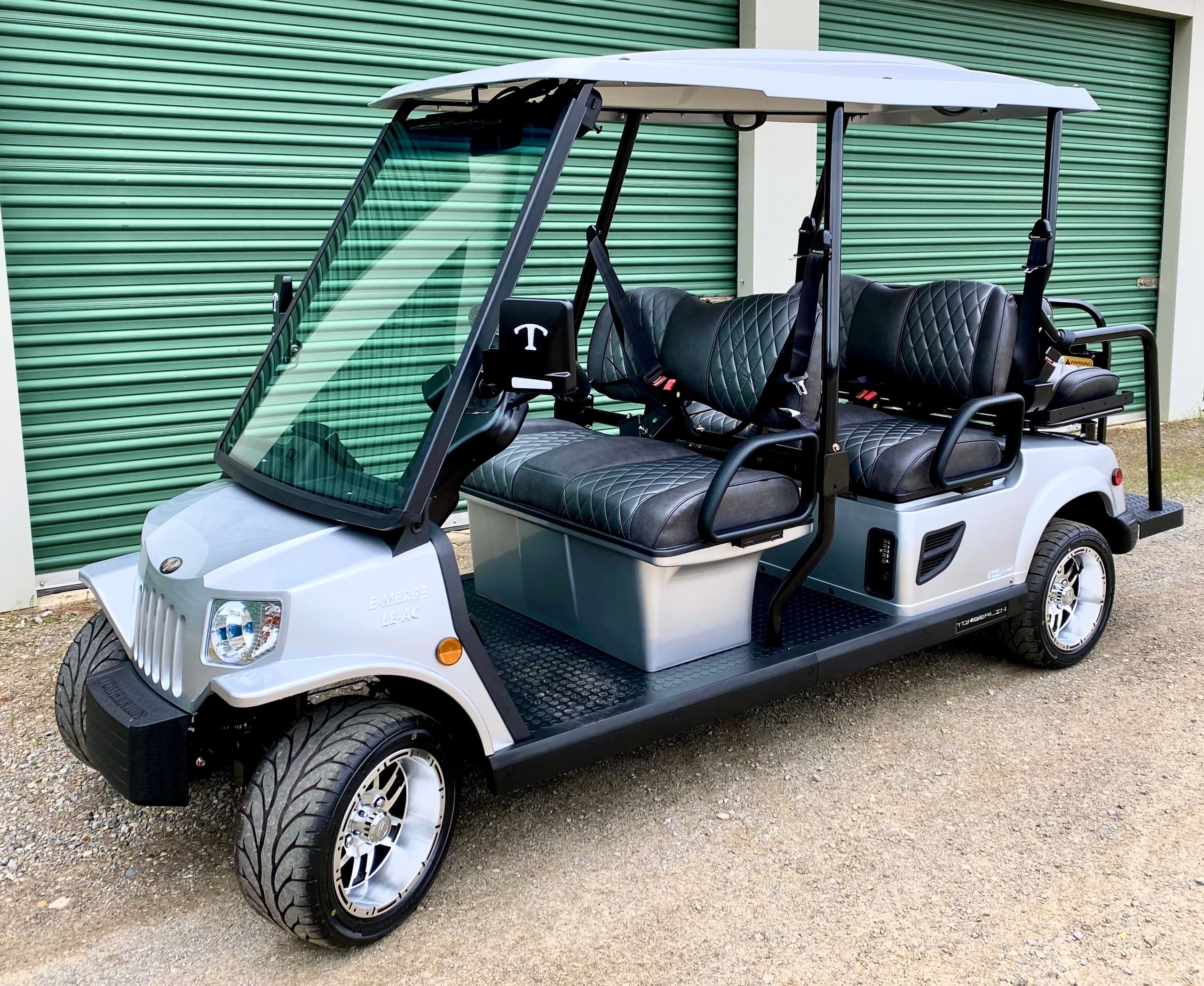 Four-seat golf cart parked outdoors, ready for course rides