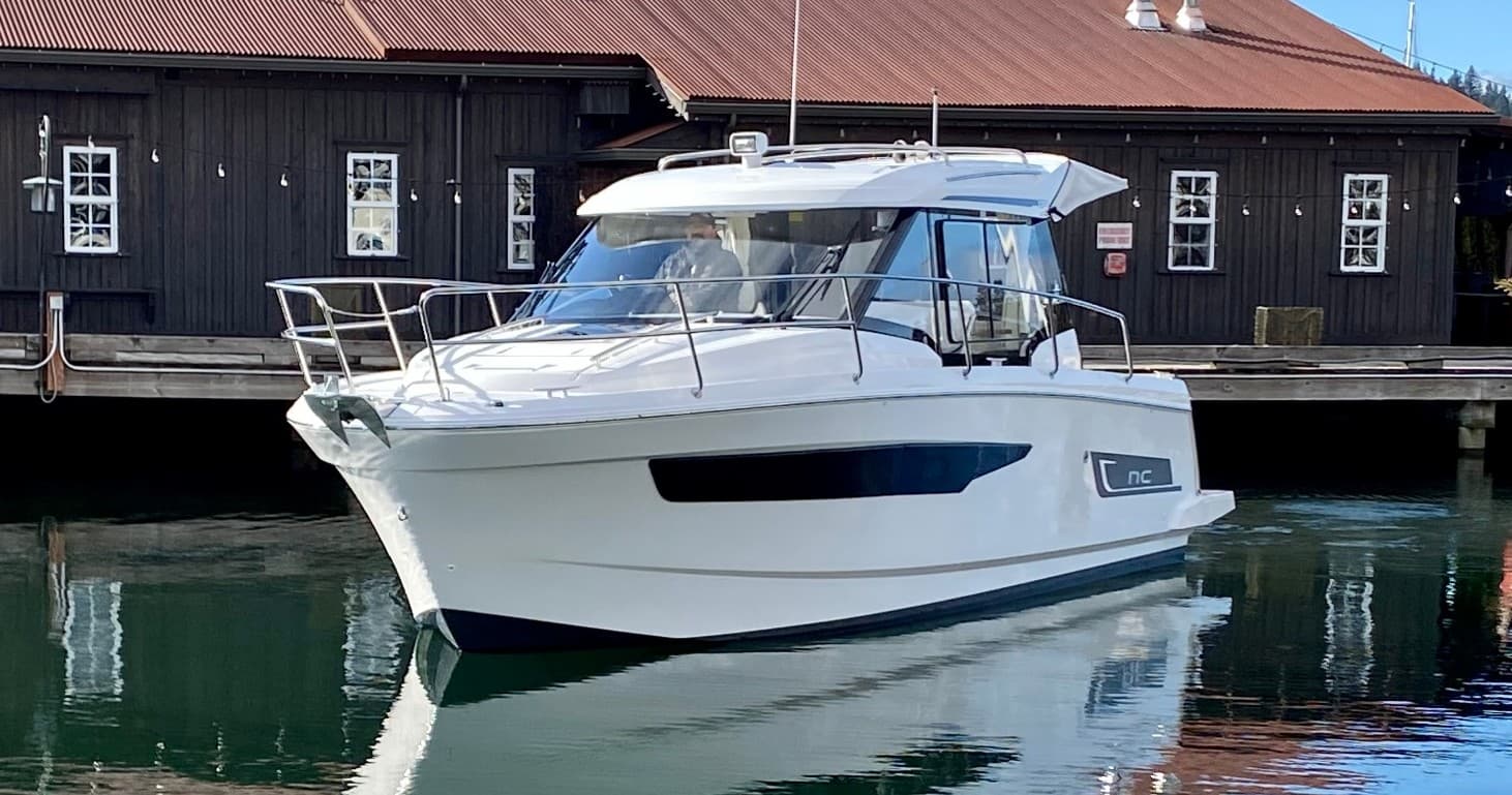 Motorboat docked at marina on calm coastal harbor