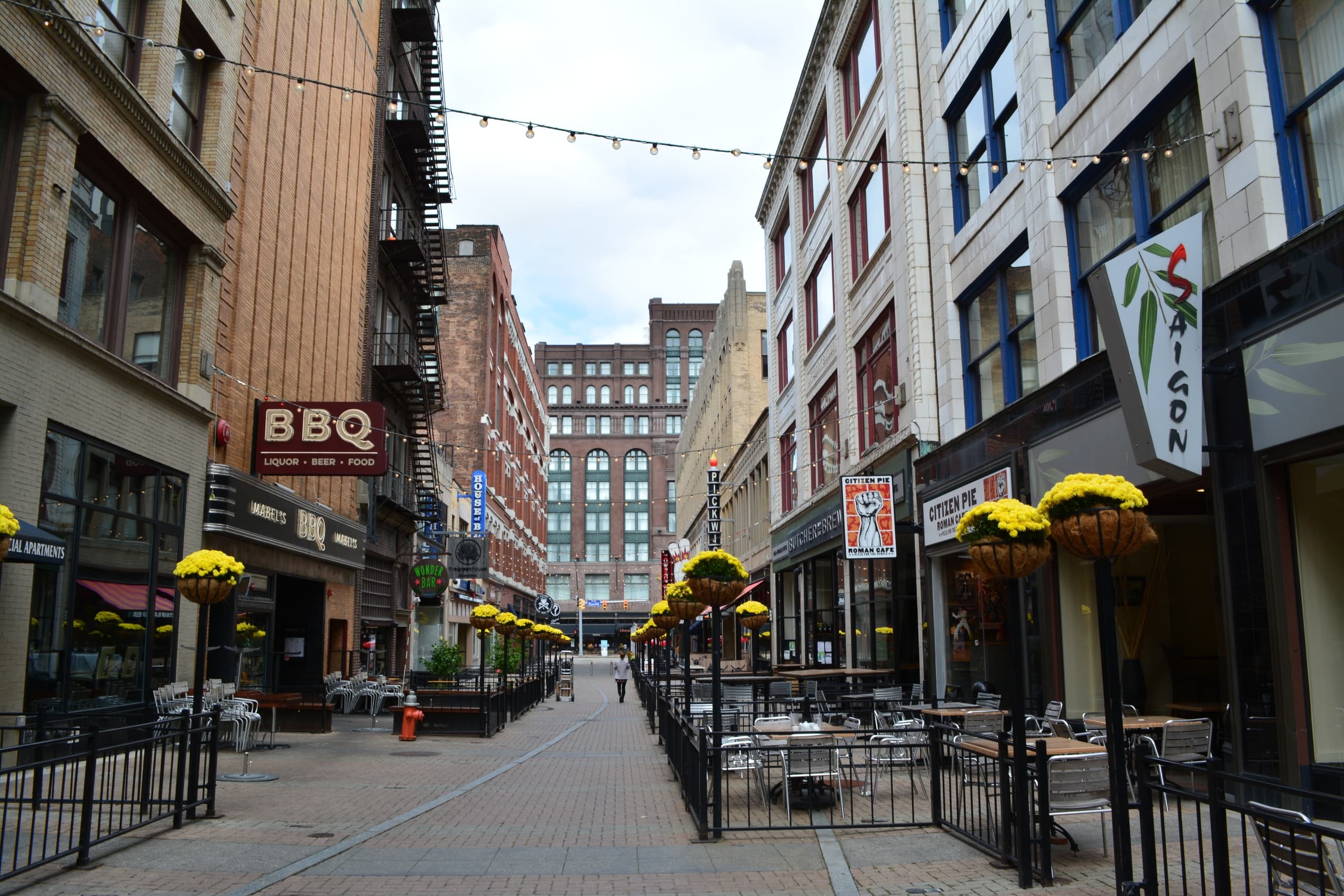 Outdoor pedestrian dining street in city center with seating