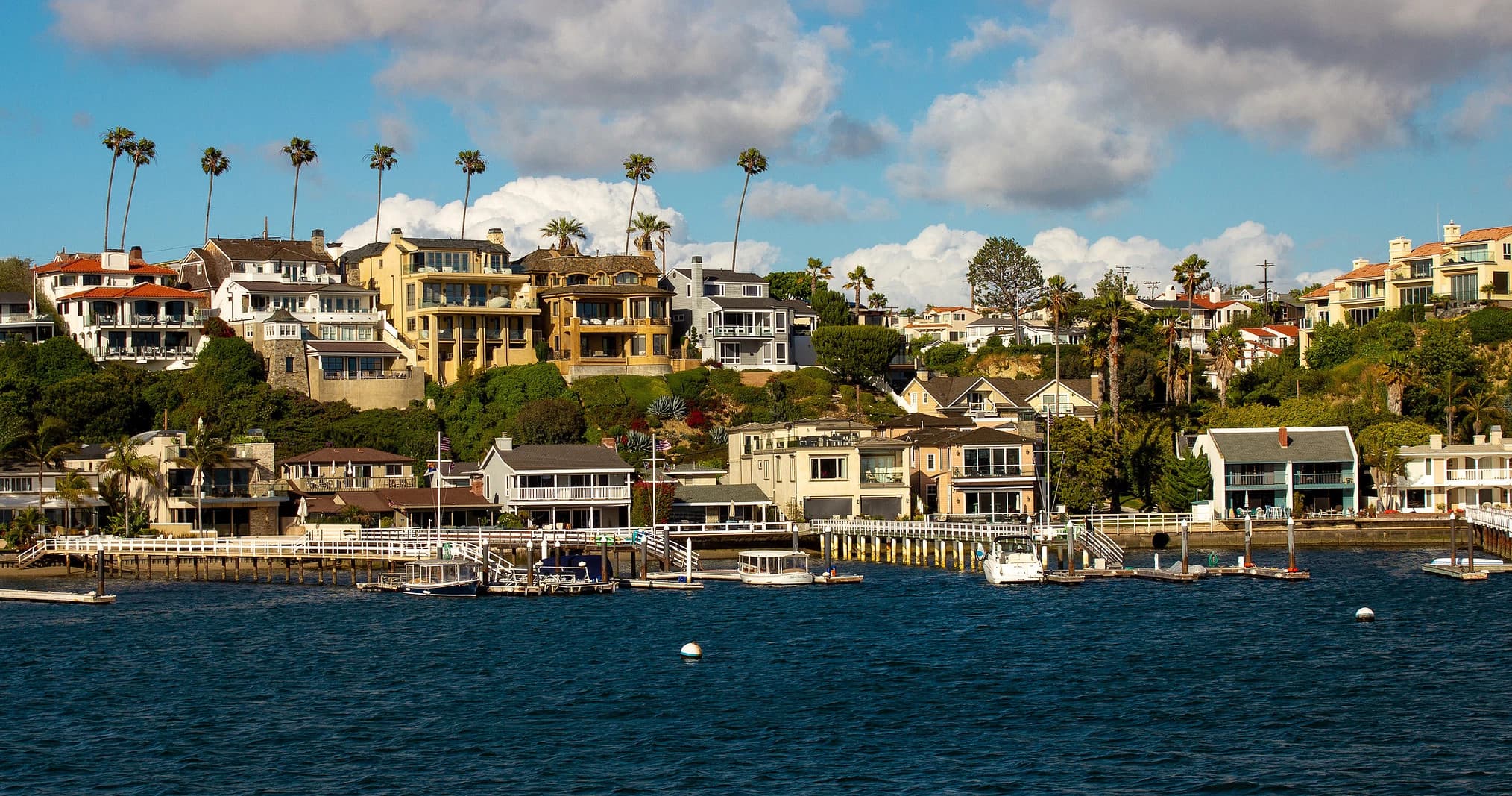 Coastal harborfront homes and docks along calm bay