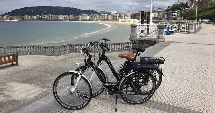 Parked bicycles along seaside promenade with ocean view