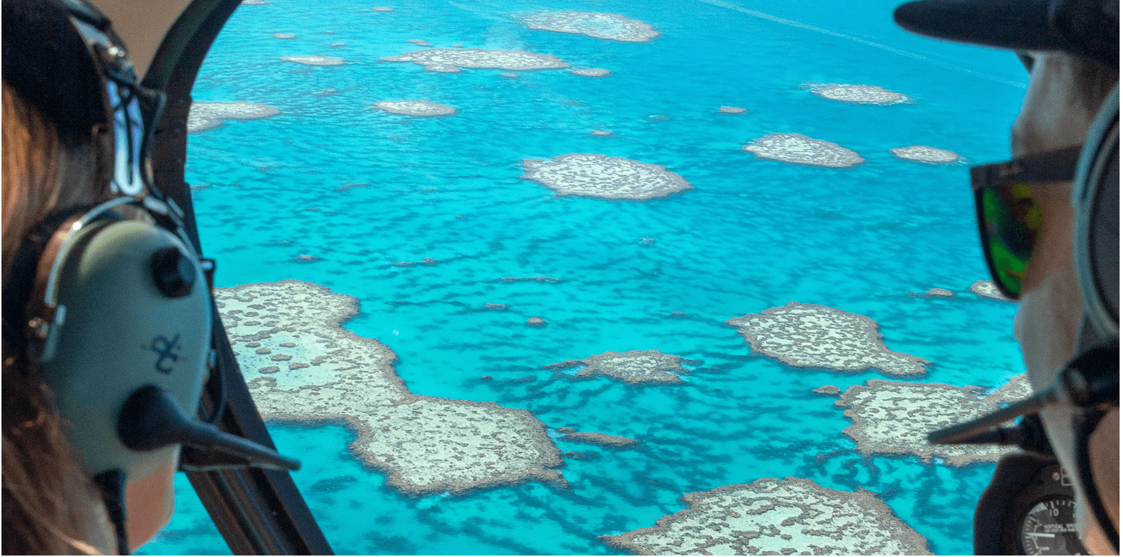 Scenic helicopter window view of reef patches, aerial sightseeing