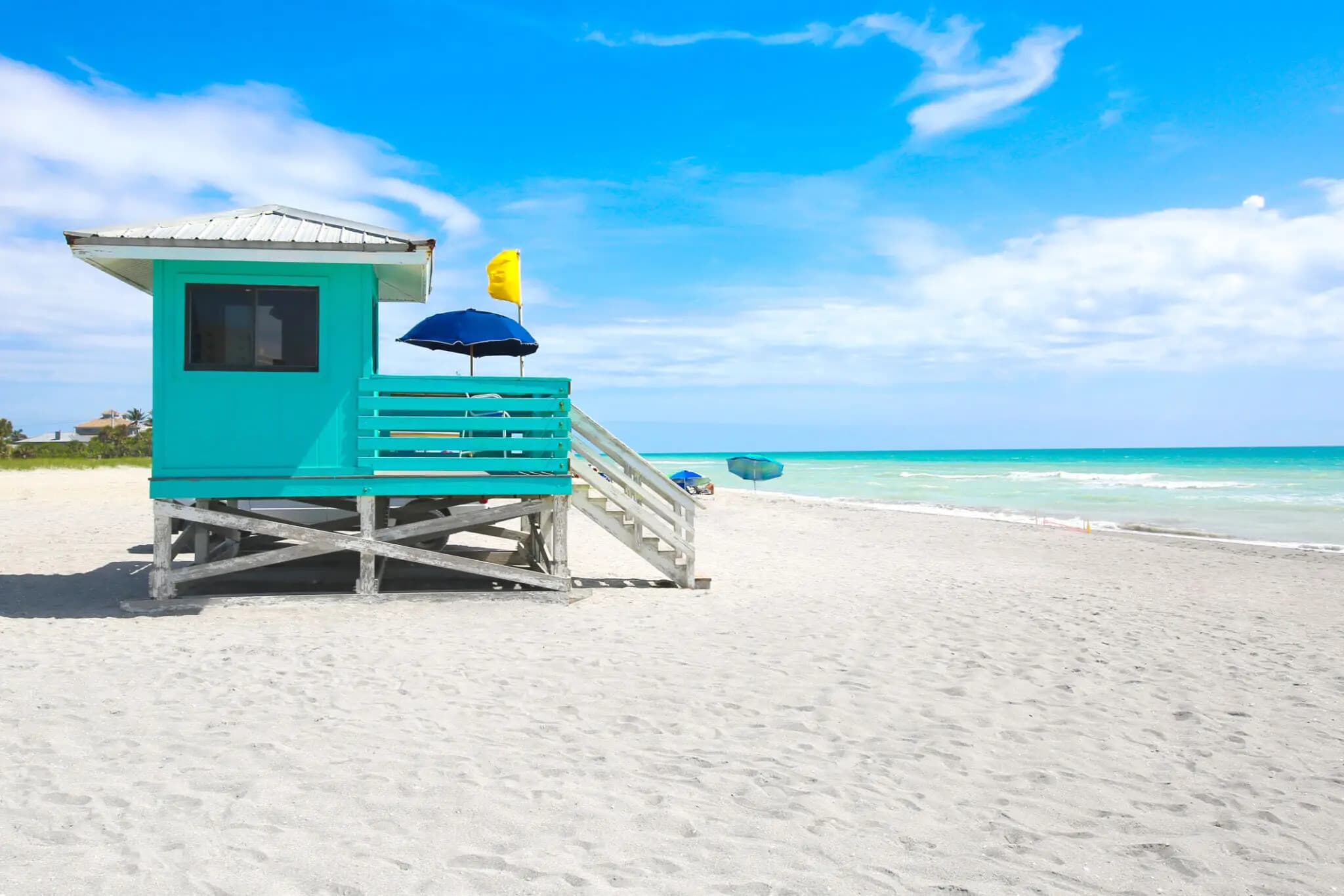 Turquoise lifeguard hut on white sand beach, Gulf coast