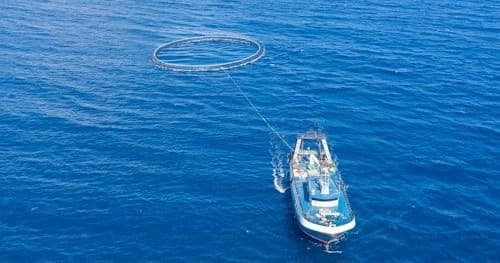 Aerial view of fishing charter boat on deep blue ocean