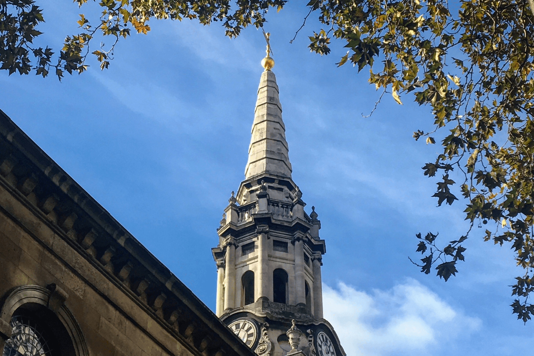 Church spire against blue sky, classic London ecclesiastical skyline
