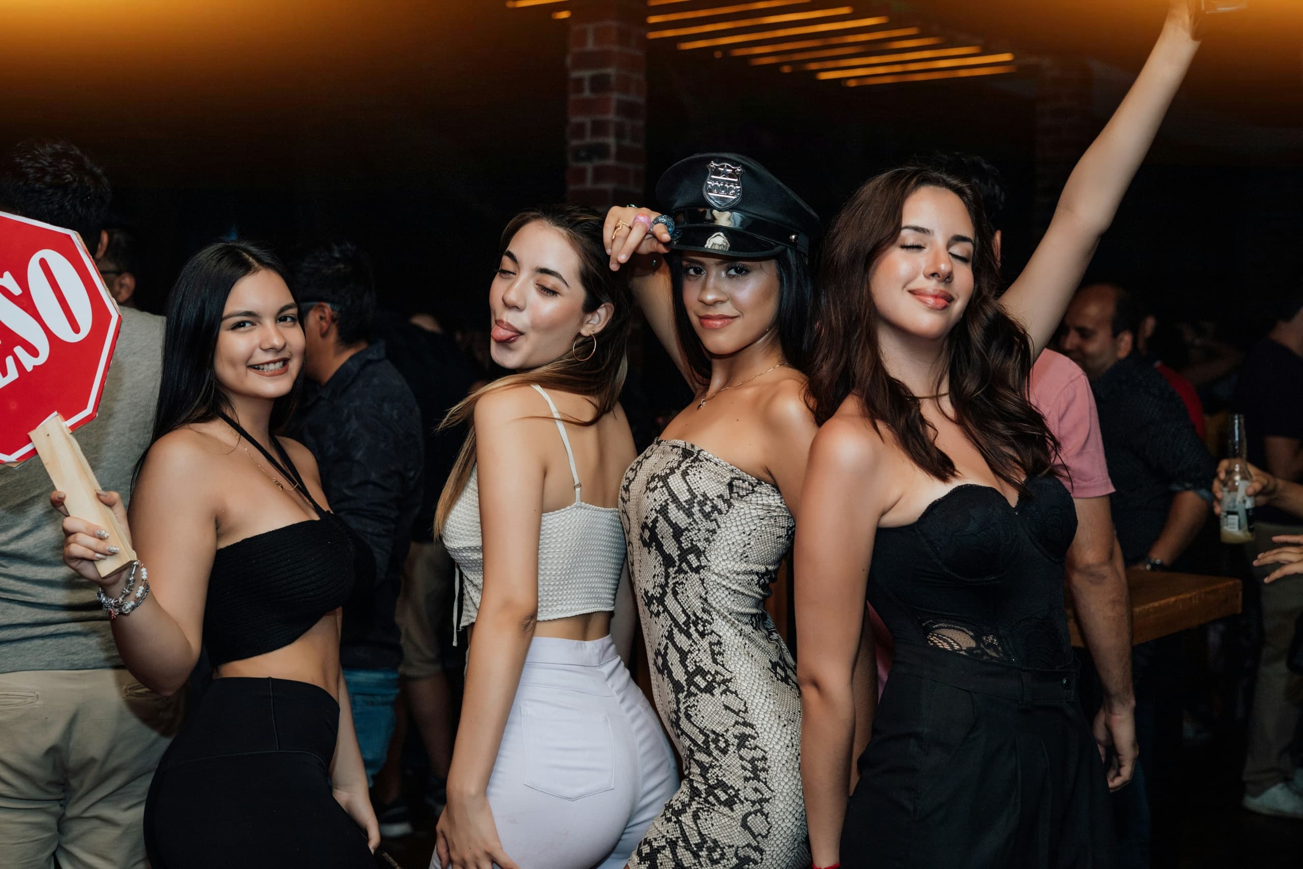 Women posing at lively bar nightclub during nightlife celebration