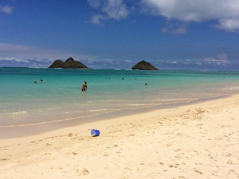 People swimming at tropical Lanikai beach with offshore islets