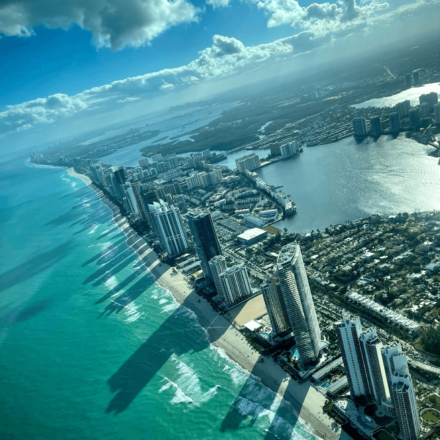 Aerial helicopter tour over Miami Beach skyline and turquoise ocean