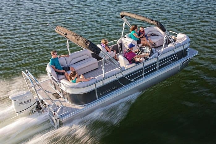 Aerial pontoon boat speeding on Marina del Rey waters with passengers
