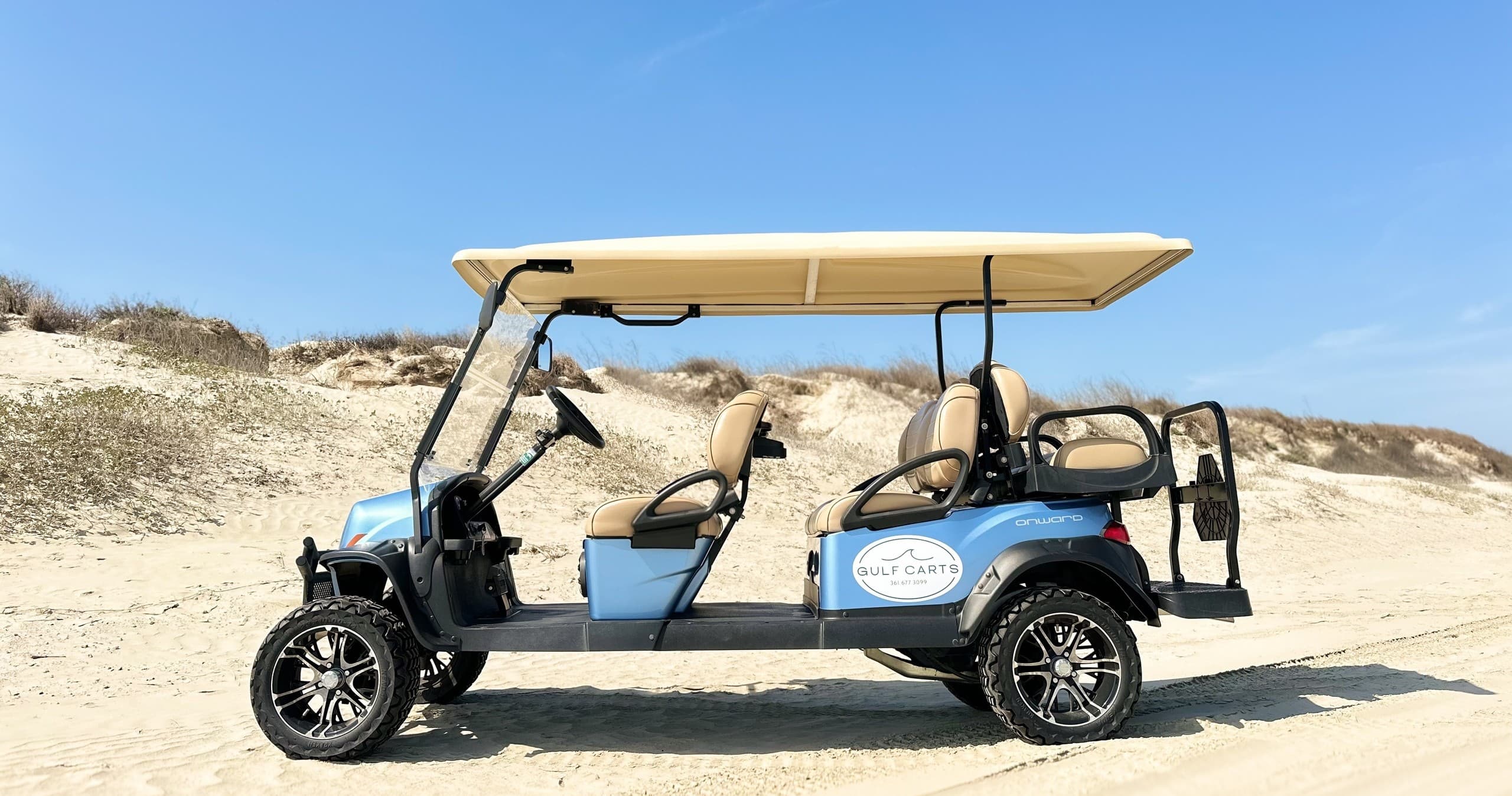 Beach golf cart rental cruising sandy dunes on sunny Gulf Coast