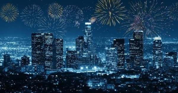 City skyline at night with fireworks over downtown, celebratory view