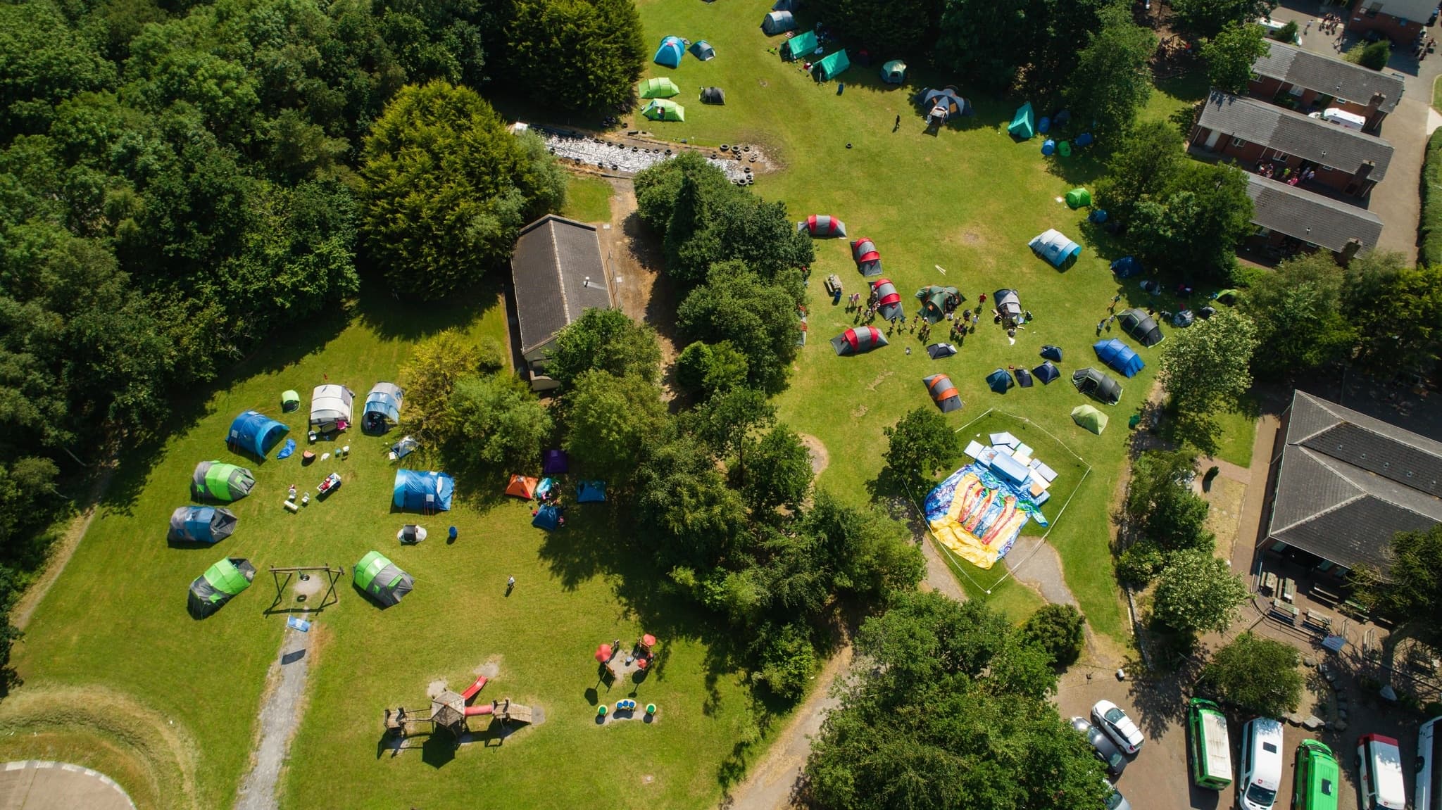 Top-down view of family campsite on green lawn, outdoor fun