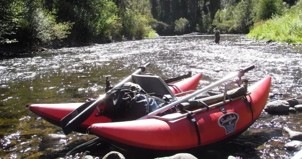 Inflatable rafts resting on rocky river bank before river trip