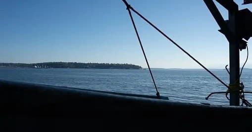 Fishing boat deck silhouette overlooking calm sea horizon