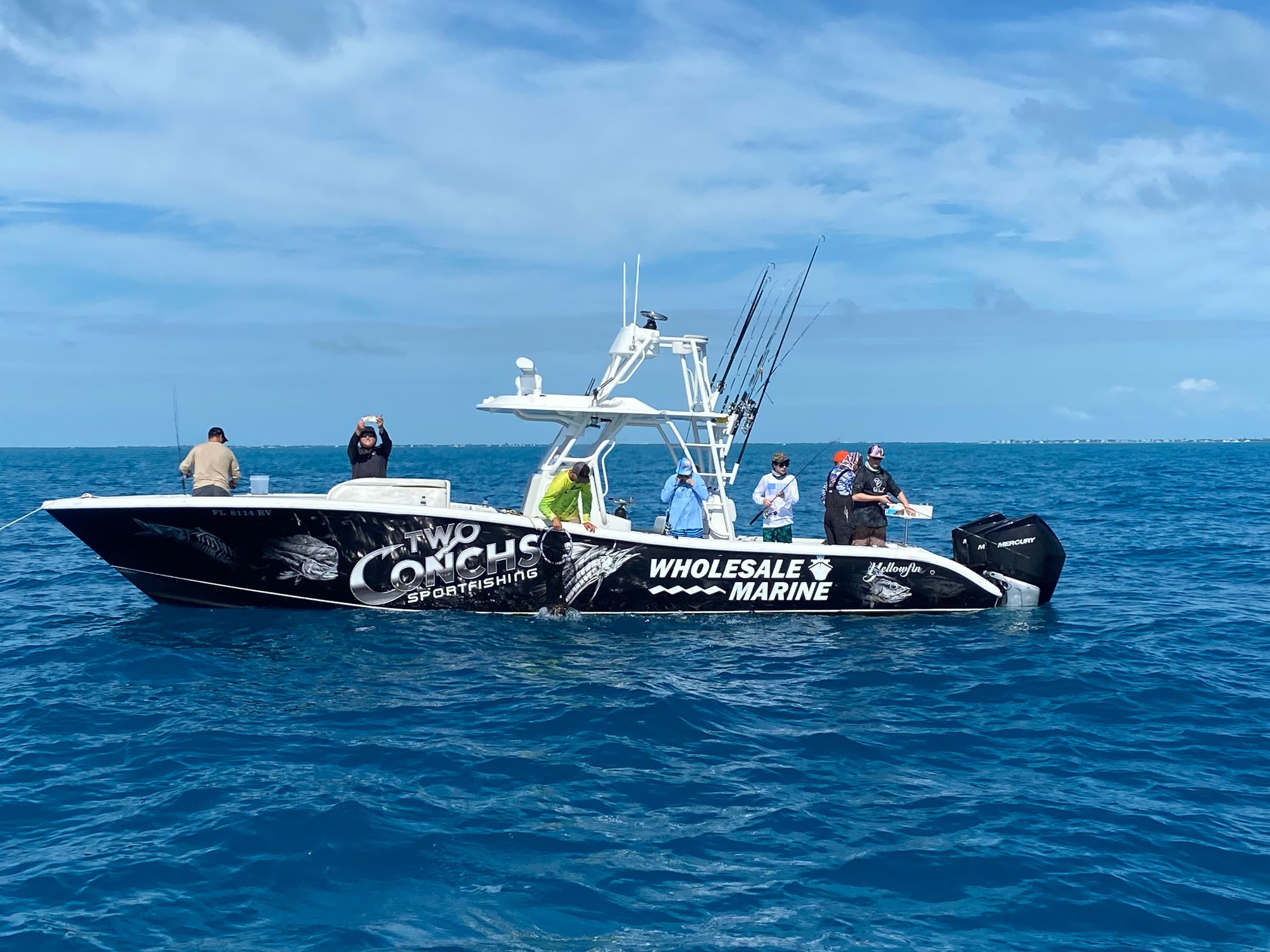 Sportfishing charter with anglers on bright blue ocean
