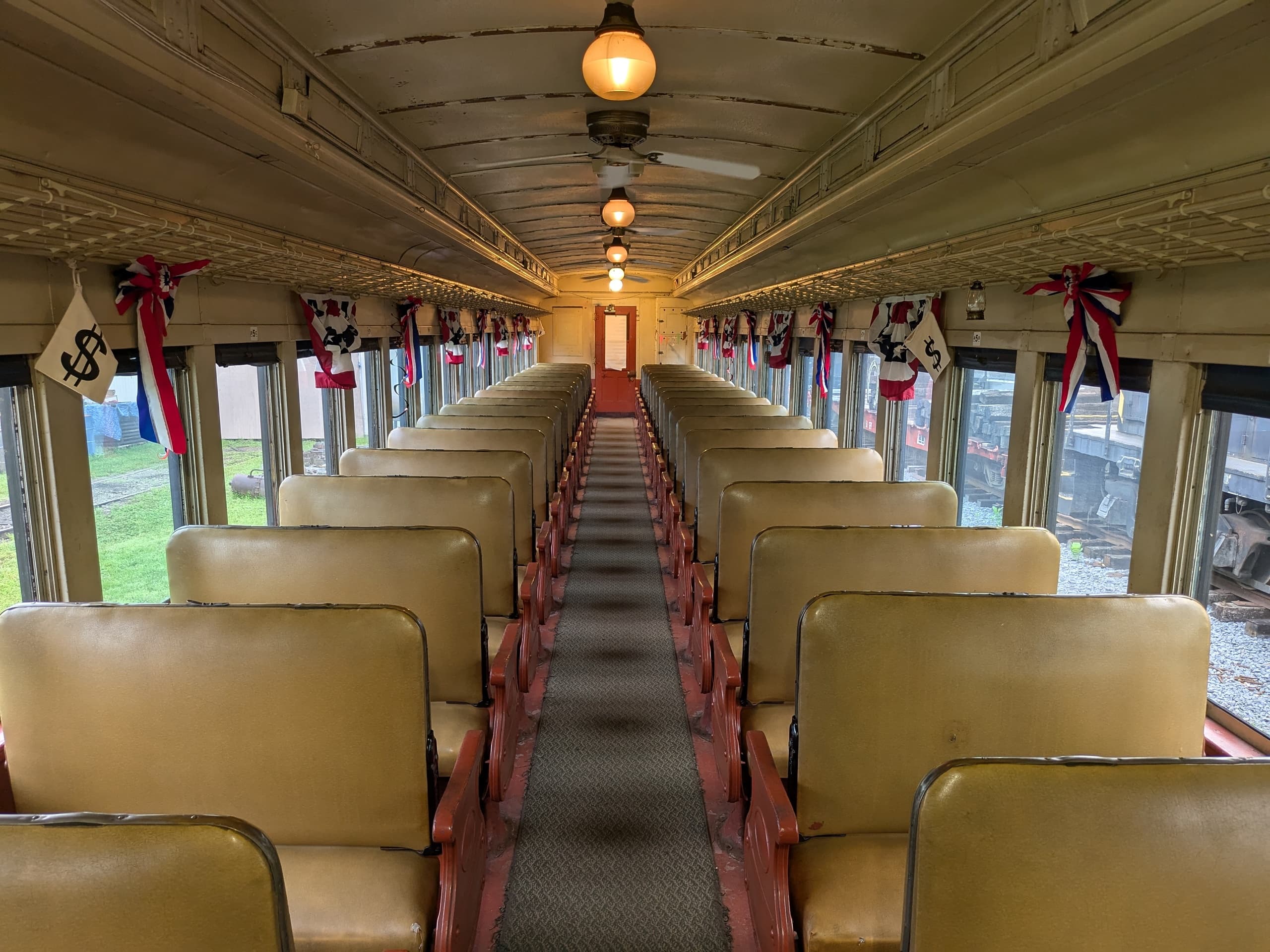 Long vintage railcar aisle with wooden seats and scenic windows