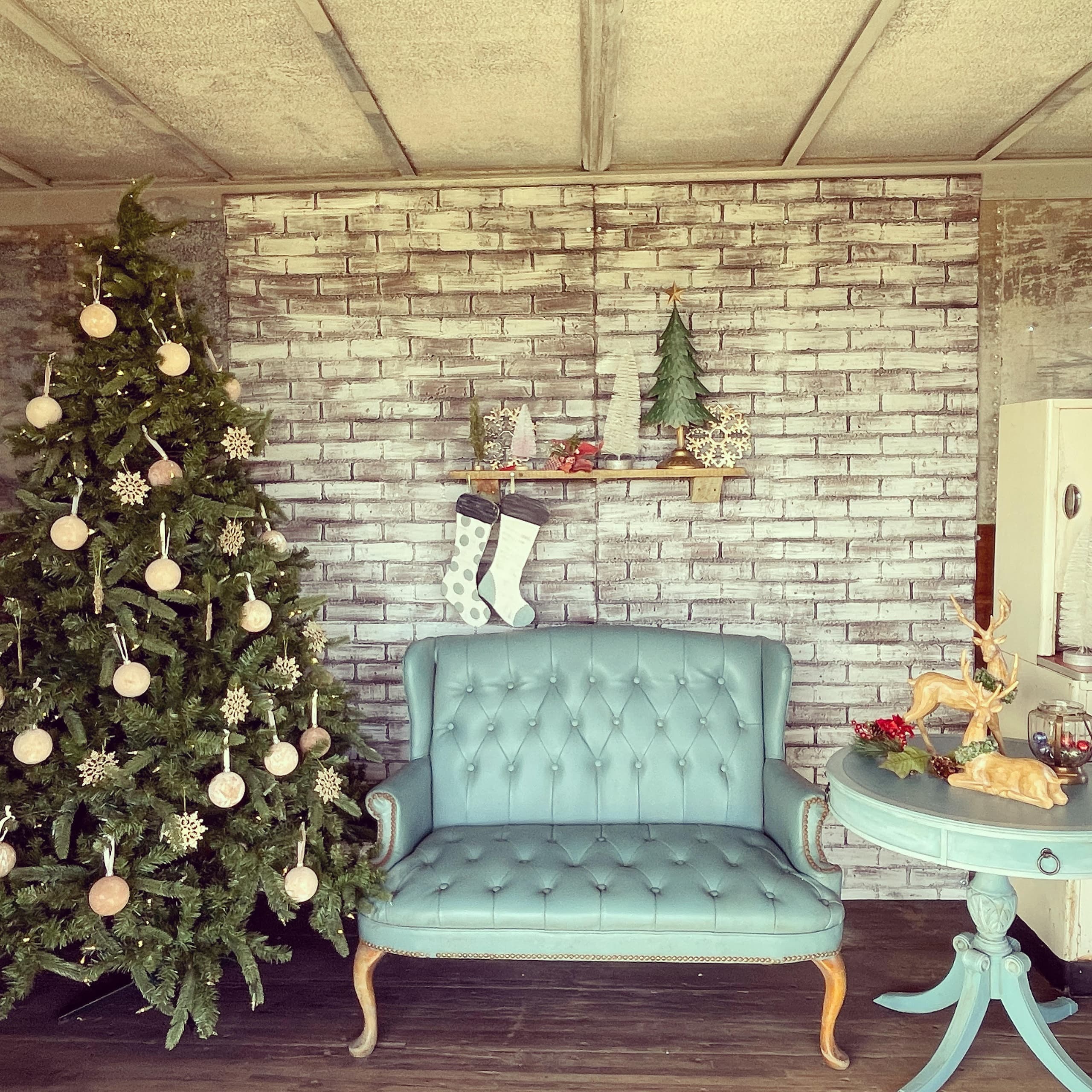 Indoor farmhouse living room styled with Christmas tree and vintage sofa