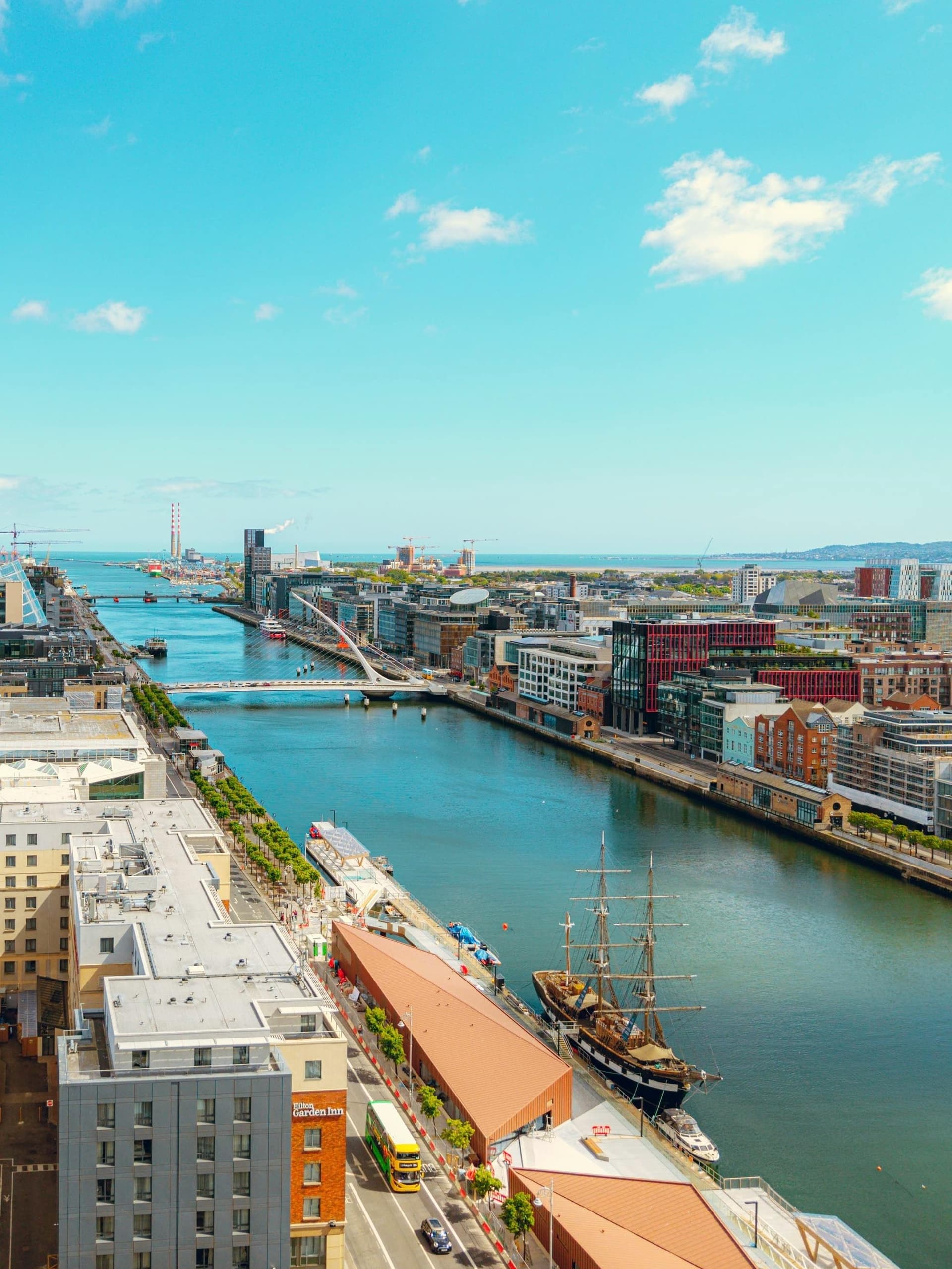 Aerial view of coastal city riverfront and harbor in daylight