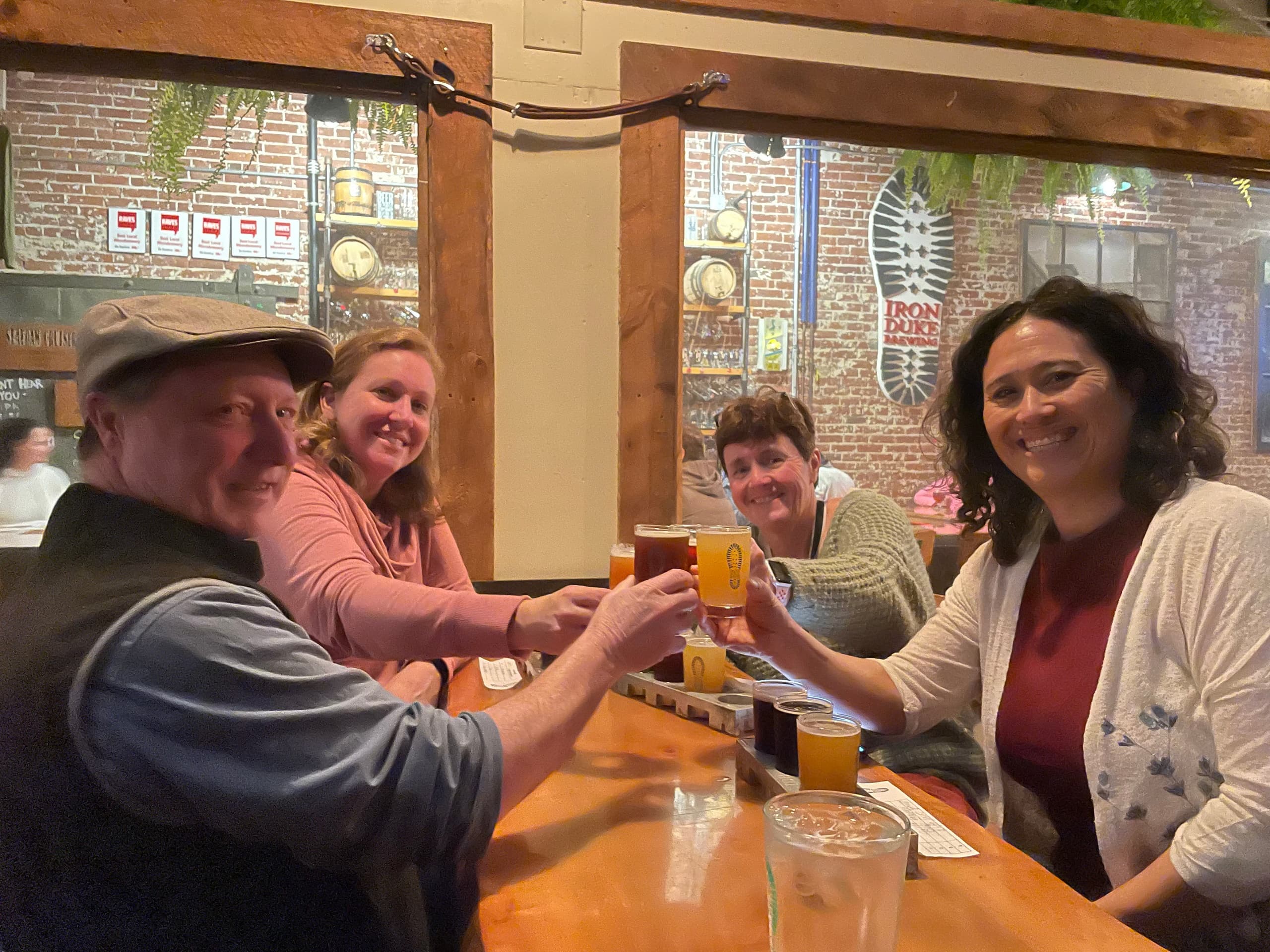 Friends enjoying craft beers inside a cozy brewery taproom