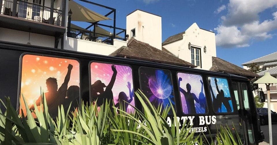 Close-up of 30A party bus with silhouetted dancers vinyl wrap