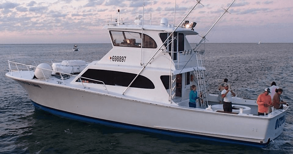 Private charter crew trolling nearshore waters at sunset cruise
