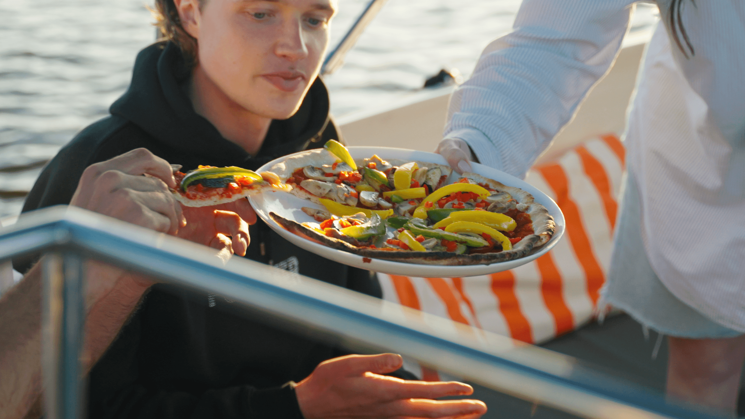 Guests sharing seafood plate on deck during scenic Dutch boat tour ride