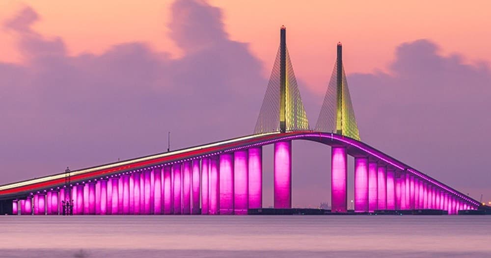 Scenic illuminated waterfront bridge at dusk for coastal sightseeing