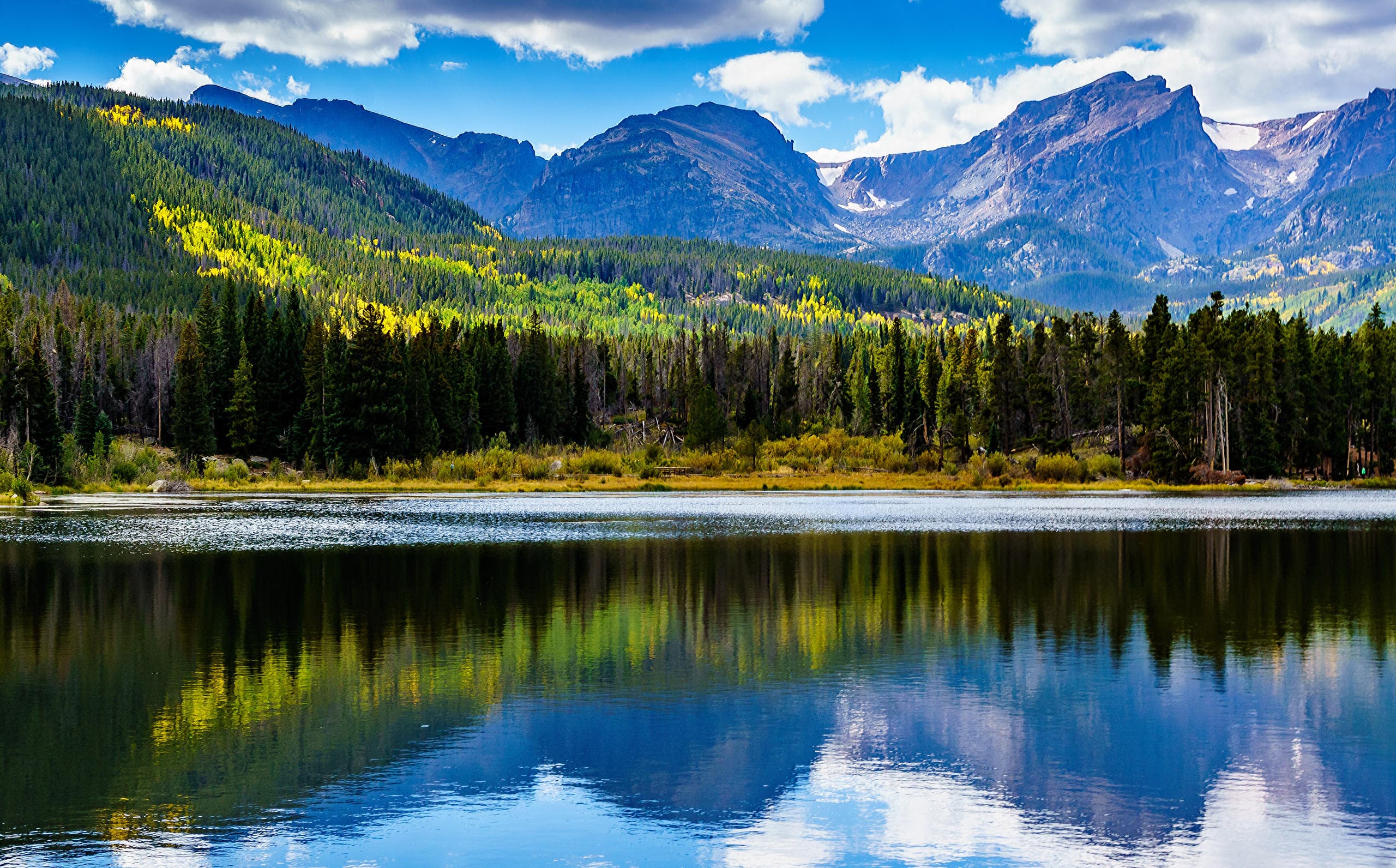 Alpine lake reflecting Rocky Mountain peaks for scenic hiking