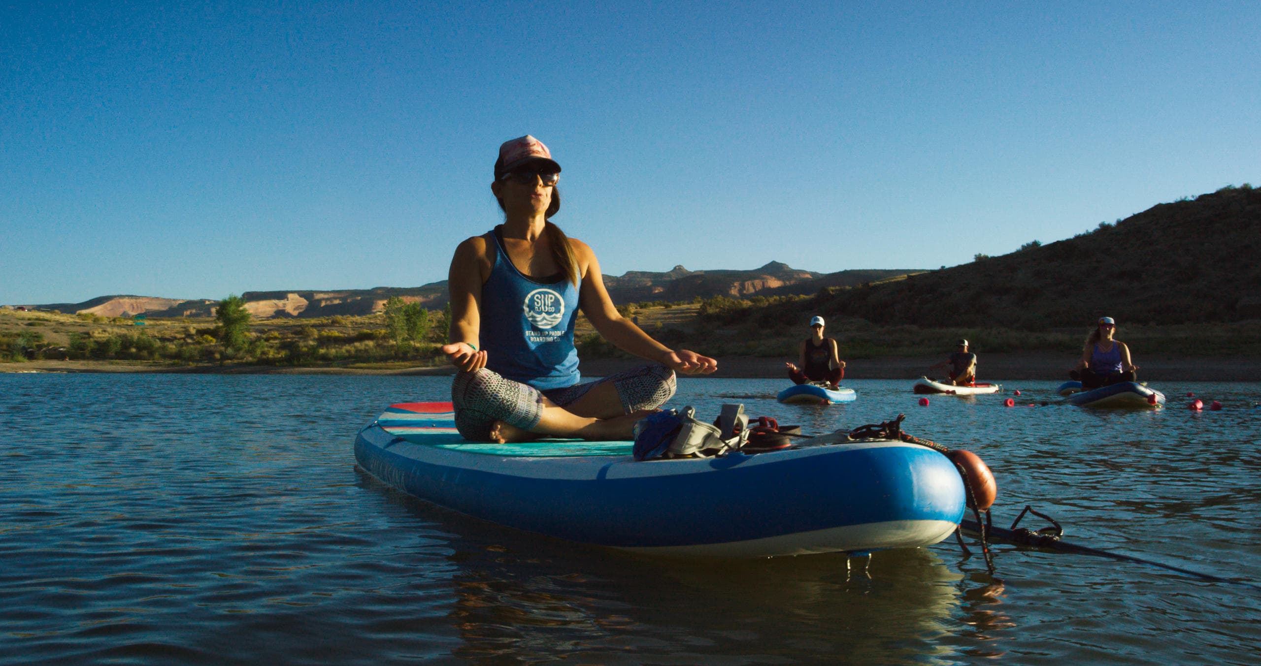 Guide seated on inflatable kayak during sunny river trip