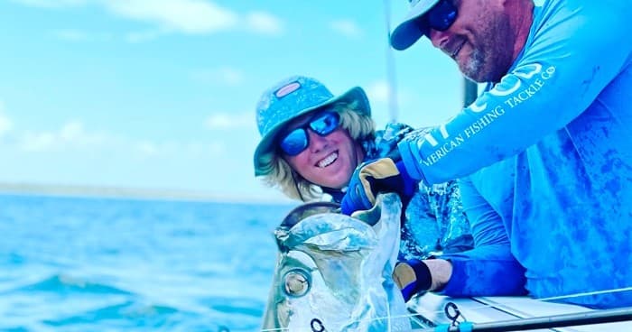 Anglers releasing large fish from boat during bluewater fishing