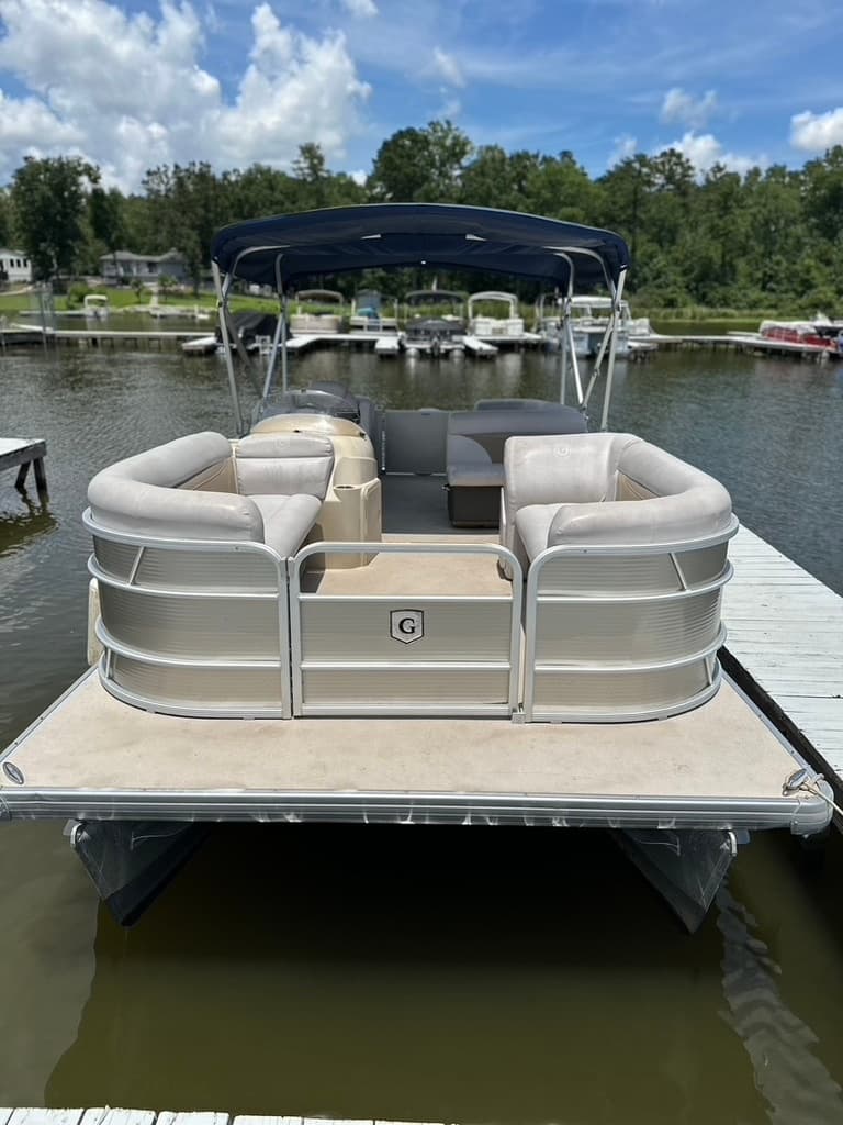 Pontoon boat docked at lake marina for leisure boating